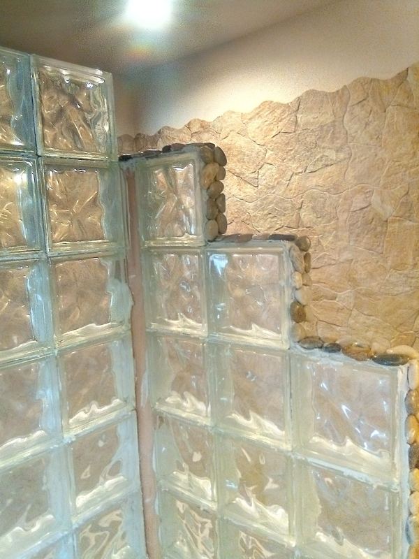 The stepped glass block wall enclosing the shower.