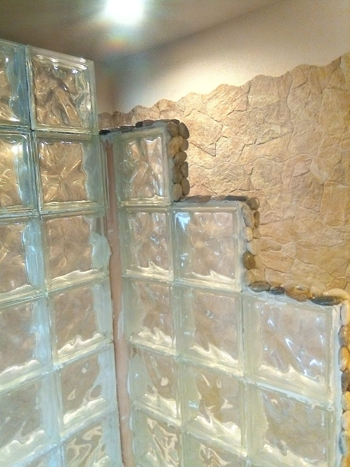 The stepped glass block wall enclosing the shower.