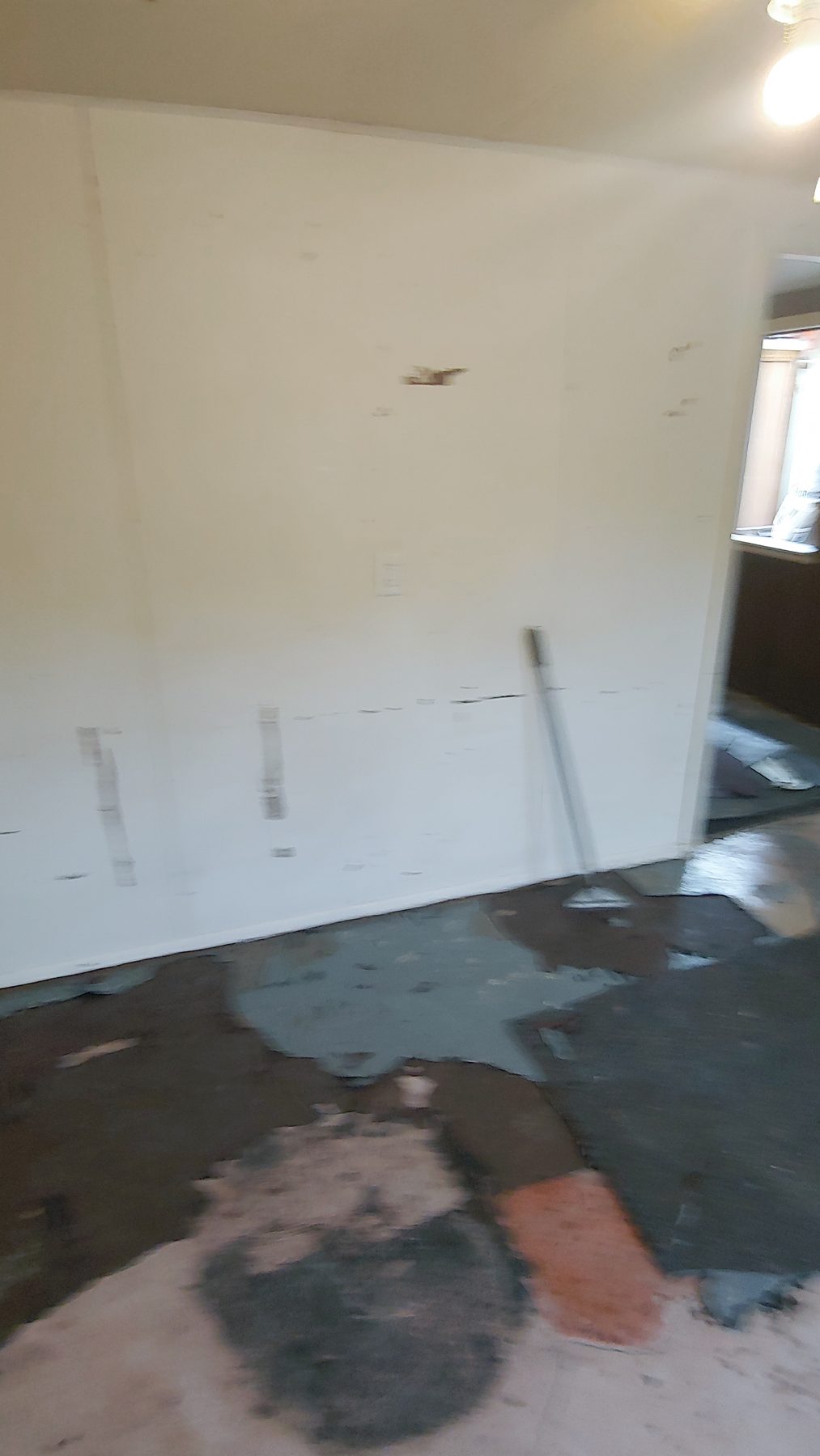 Before: the main room with old flooring lifted out.