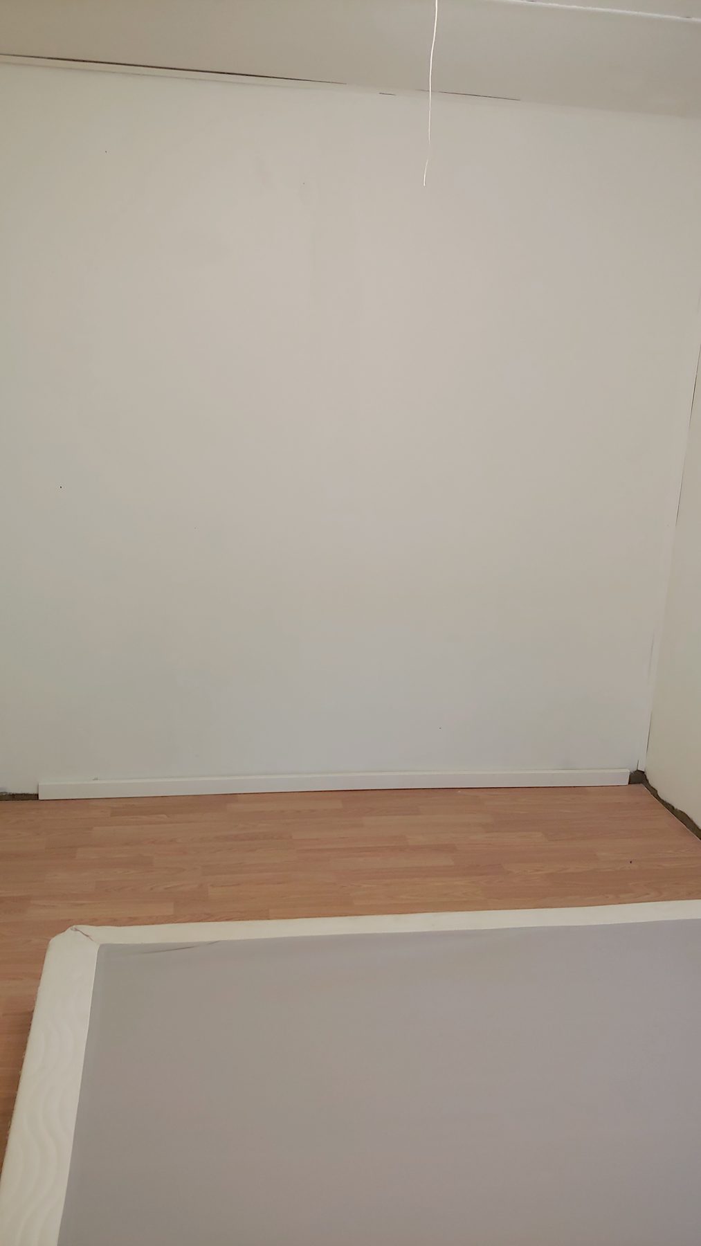 After: new bath surround and tub set against fresh wall finish.