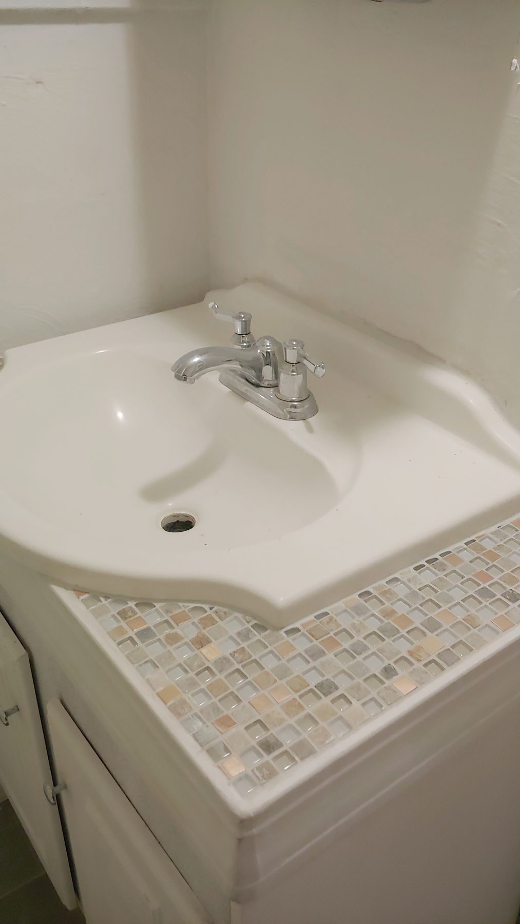 After: the finished vanity with mosaic tile top.